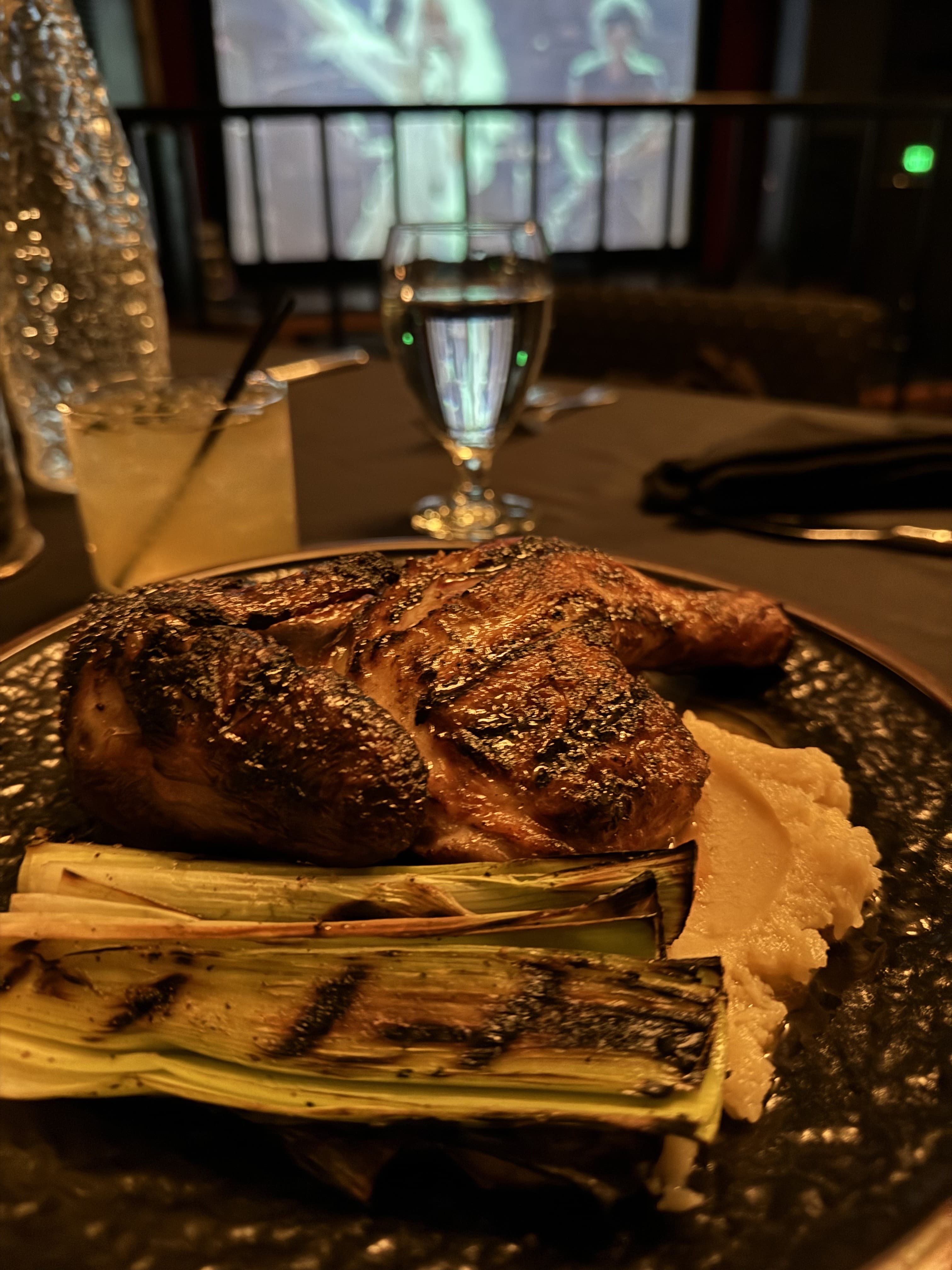 Roasted Cornish hen with grilled leeks during a dinner theater show